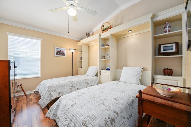 bedroom featuring wood finished floors, baseboards, ceiling fan, ornamental molding, and vaulted ceiling