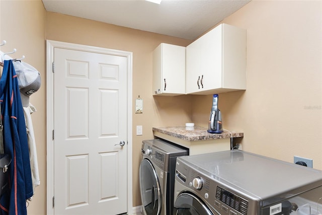 laundry room with cabinet space and separate washer and dryer