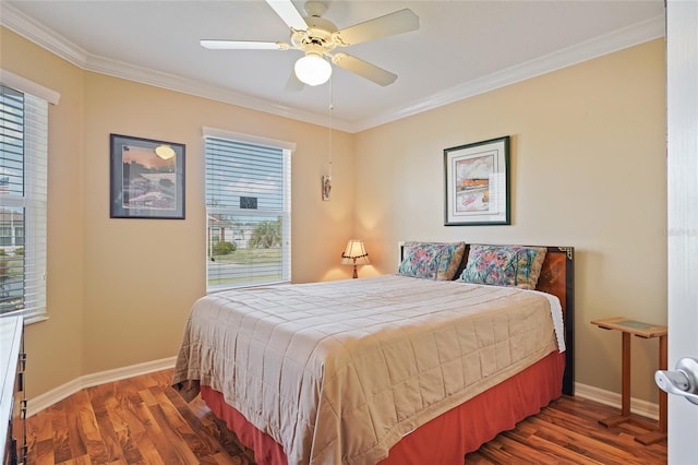 bedroom with ornamental molding, a ceiling fan, baseboards, and wood finished floors