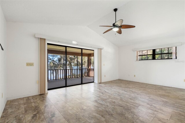 unfurnished room featuring lofted ceiling, a ceiling fan, and baseboards