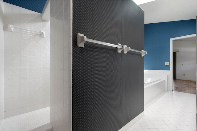 bathroom featuring a tile shower, a bath, and tile patterned floors