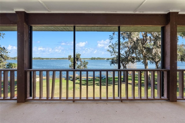 unfurnished sunroom with a water view and a wealth of natural light