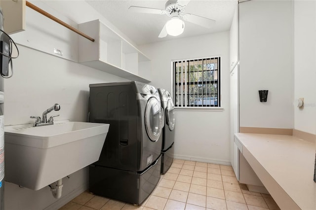 washroom featuring light tile patterned floors, laundry area, a sink, a ceiling fan, and independent washer and dryer