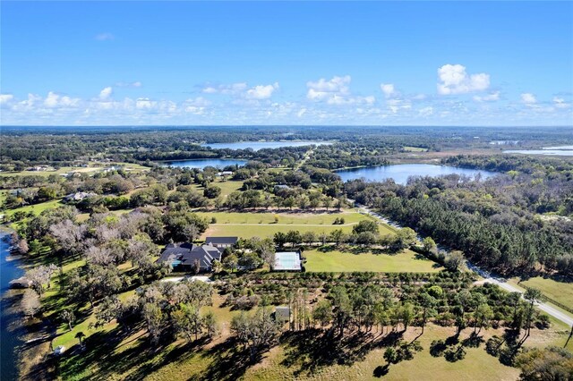 aerial view with a water view and a forest view