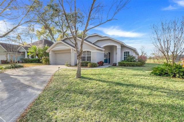 single story home featuring an attached garage, driveway, a front lawn, and stucco siding