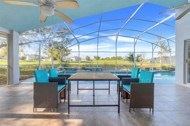 view of patio / terrace featuring a lanai, an outdoor pool, and ceiling fan