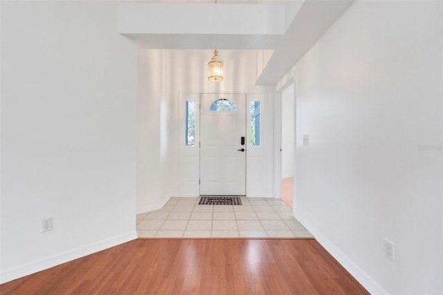 foyer entrance featuring light wood-type flooring and baseboards