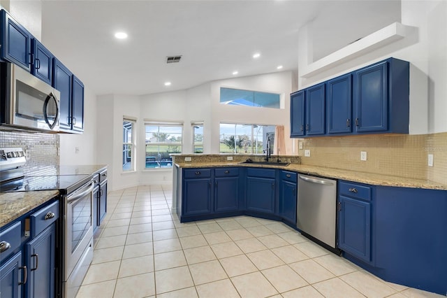 kitchen featuring light tile patterned floors, stainless steel appliances, visible vents, a sink, and blue cabinets