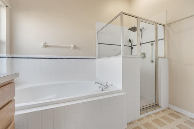 bathroom with a shower stall and a bath