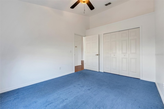 unfurnished bedroom with a closet, visible vents, a ceiling fan, carpet flooring, and baseboards