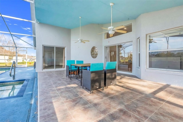 view of patio / terrace featuring glass enclosure, ceiling fan, and an outdoor pool