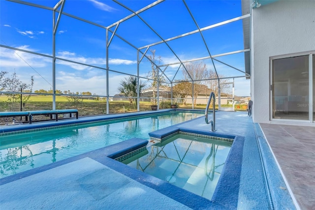 view of pool featuring a lanai, a pool with connected hot tub, and a patio