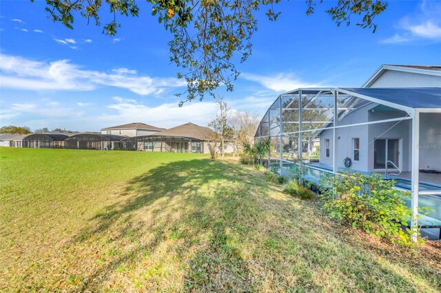 view of yard with glass enclosure