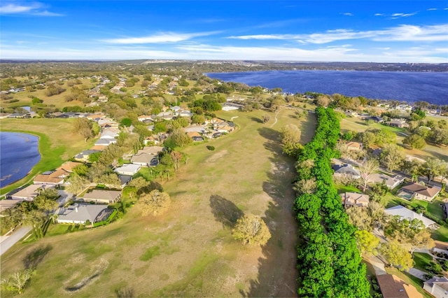 drone / aerial view with a water view and a residential view