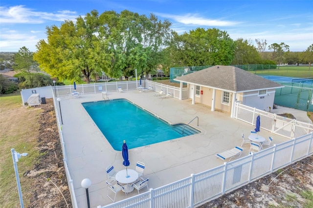 pool featuring a patio and fence