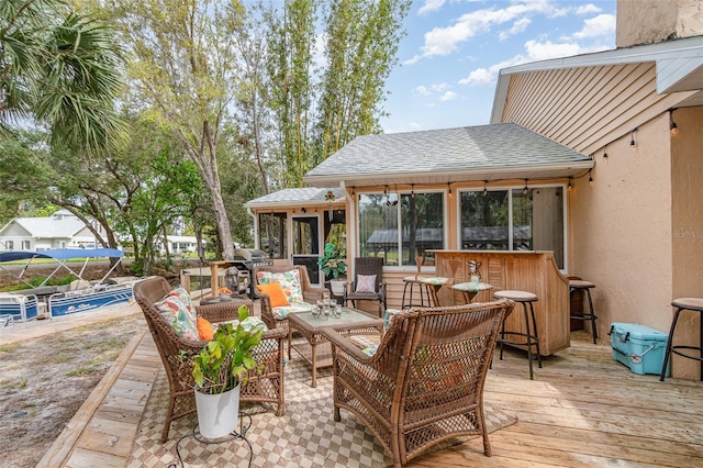 view of patio / terrace with outdoor lounge area, a sunroom, and a deck