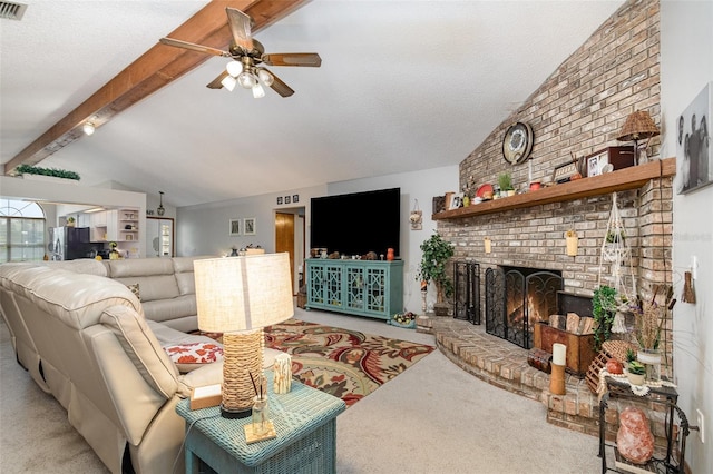 carpeted living room with visible vents, a ceiling fan, lofted ceiling with beams, a textured ceiling, and a fireplace