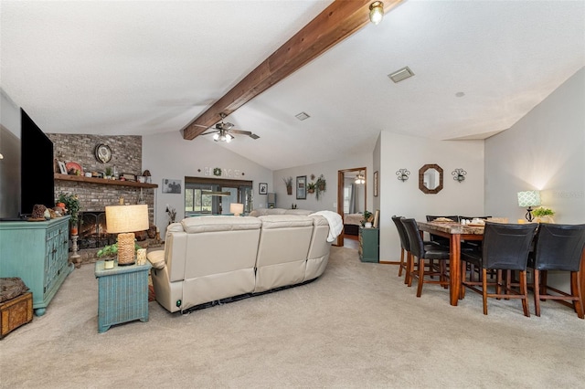 carpeted living area featuring lofted ceiling with beams, ceiling fan, a textured ceiling, a fireplace, and visible vents