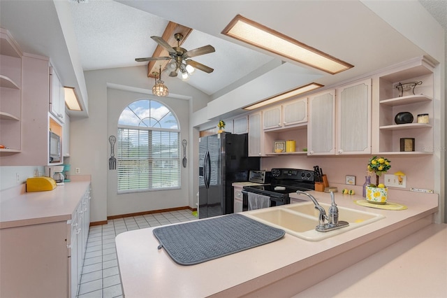 kitchen featuring open shelves, light countertops, a sink, a peninsula, and black appliances