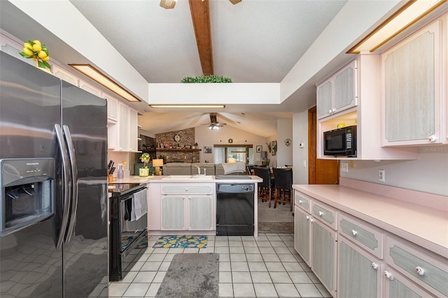 kitchen featuring light countertops, open floor plan, ceiling fan, a peninsula, and black appliances