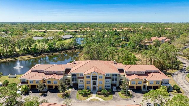 bird's eye view with a view of trees and a water view