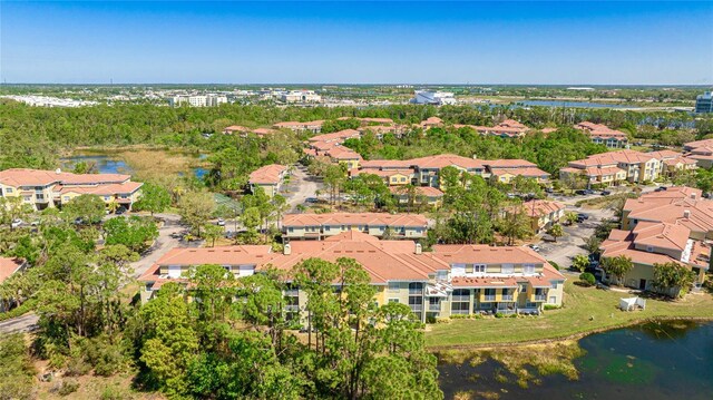 drone / aerial view with a residential view and a water view