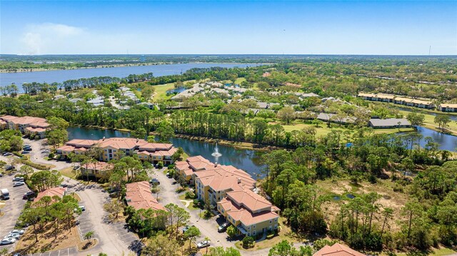 drone / aerial view with a water view and a residential view