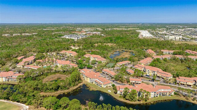 drone / aerial view with a residential view and a water view