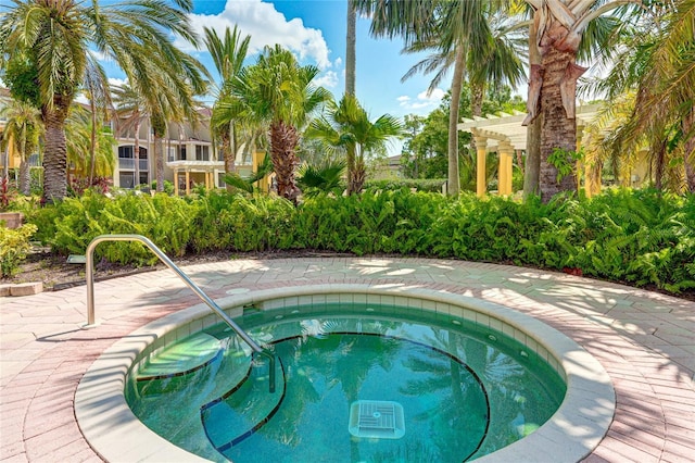 view of pool featuring a community hot tub and a pergola