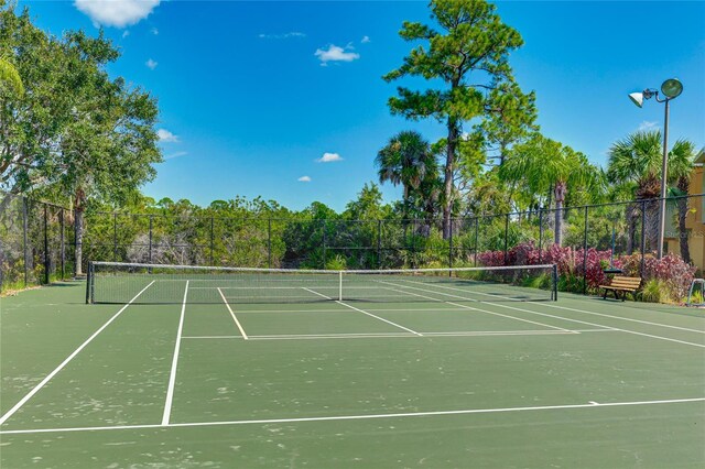 view of sport court featuring fence