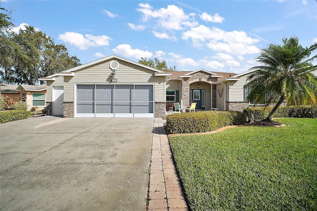 ranch-style house with an attached garage, concrete driveway, a front lawn, and stone siding