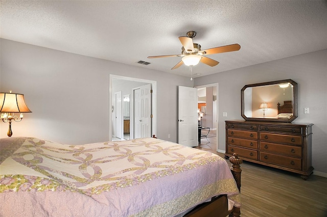 bedroom featuring a textured ceiling, ceiling fan, wood finished floors, and visible vents