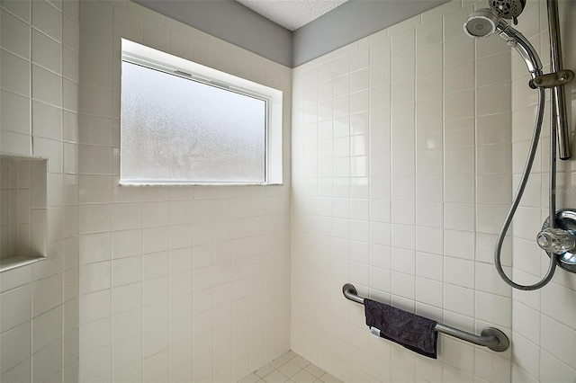 bathroom with a tile shower