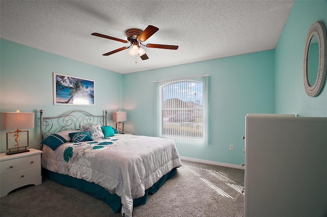 carpeted bedroom with baseboards, a ceiling fan, and a textured ceiling