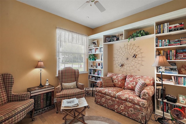 living area with ceiling fan and wood finished floors