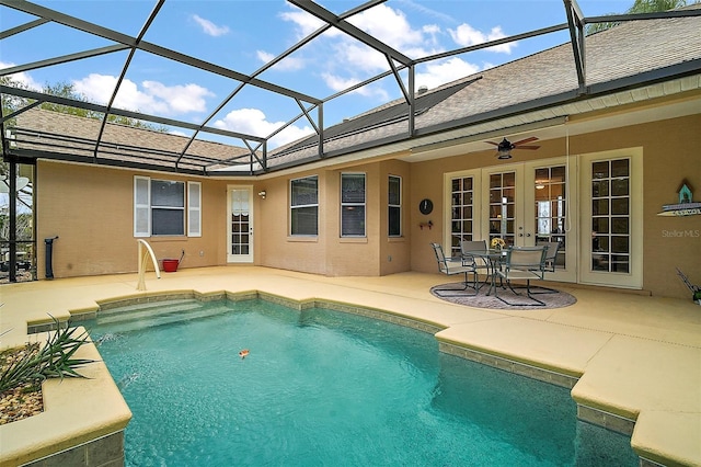 pool featuring ceiling fan, glass enclosure, french doors, and a patio area