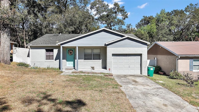 single story home with a garage, brick siding, fence, driveway, and a front lawn