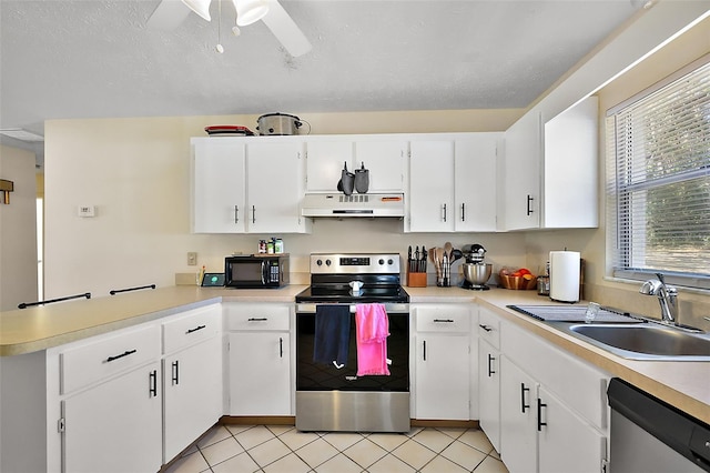 kitchen featuring appliances with stainless steel finishes, light countertops, a sink, and under cabinet range hood