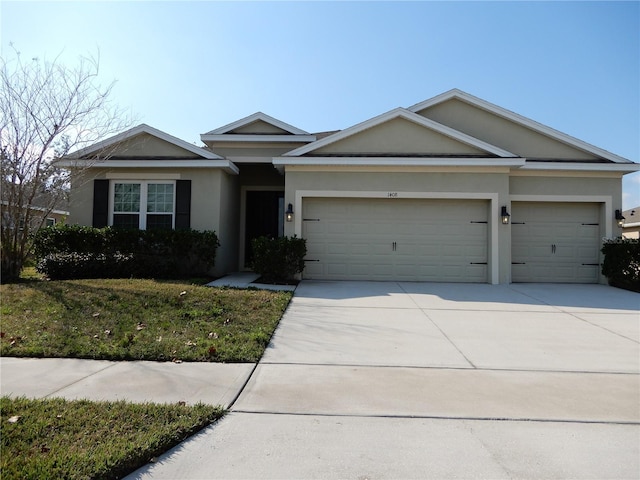 single story home with stucco siding, an attached garage, driveway, and a front yard