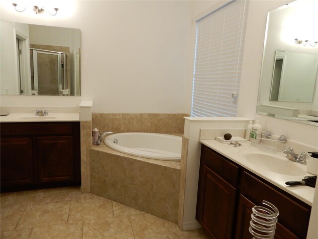 bathroom with a sink, a garden tub, a stall shower, and tile patterned floors