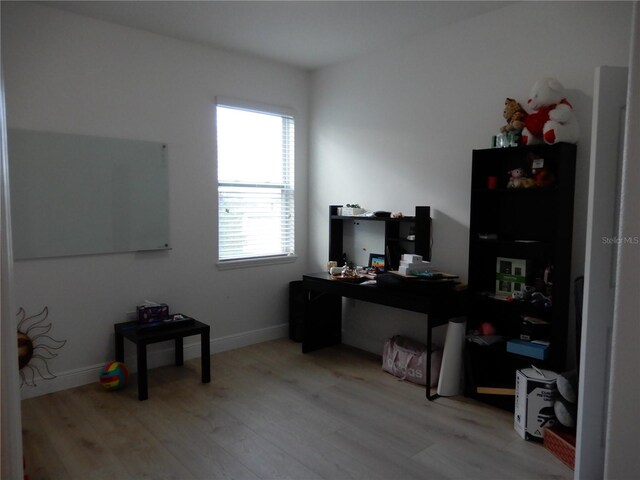 office with light wood-type flooring and baseboards