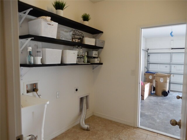 laundry room with washer hookup, light tile patterned floors, a garage, hookup for an electric dryer, and laundry area