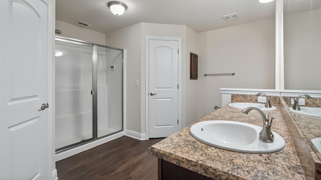 full bath with a stall shower, a sink, and visible vents