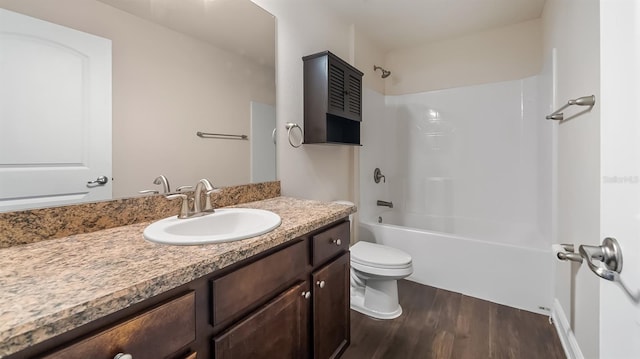 full bath with toilet, shower / bath combination, wood finished floors, and vanity