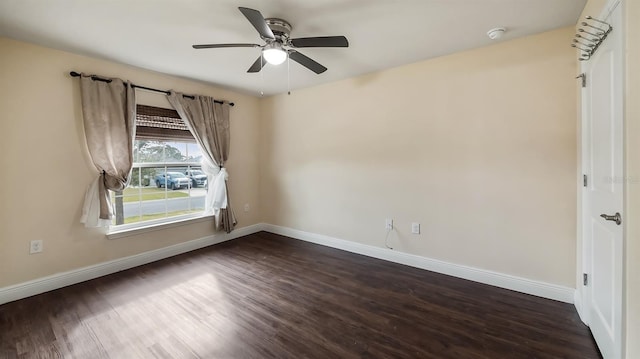 unfurnished room featuring ceiling fan, dark wood-style flooring, and baseboards