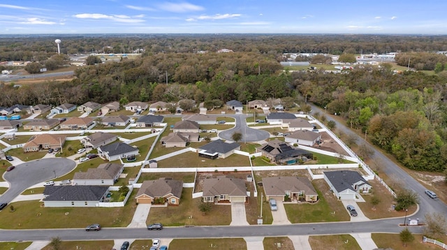 aerial view featuring a residential view and a wooded view