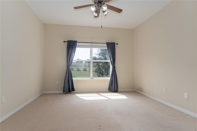 empty room featuring carpet, a ceiling fan, and baseboards