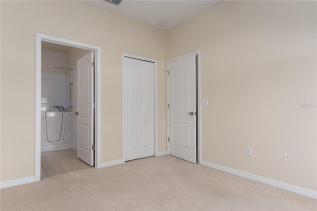 unfurnished bedroom featuring light carpet, visible vents, and baseboards