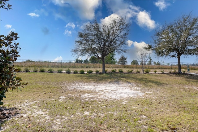 view of yard with a rural view and fence