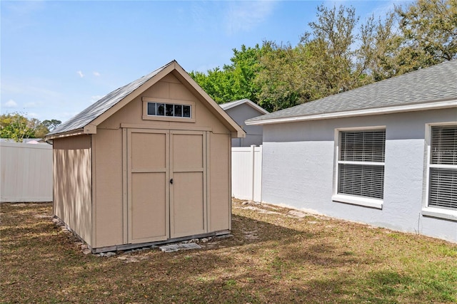 view of shed with fence